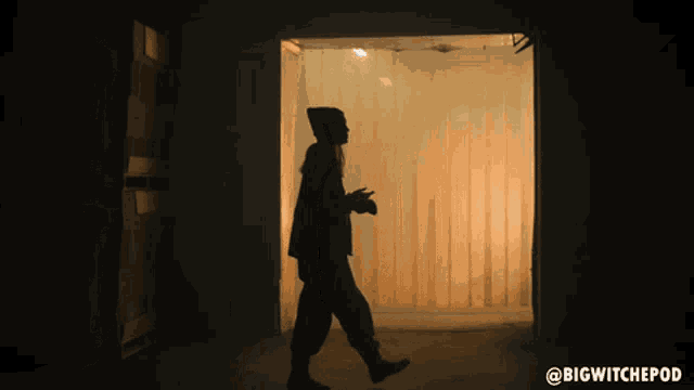 a silhouette of a person in a dark room with the words bigwitchepod below