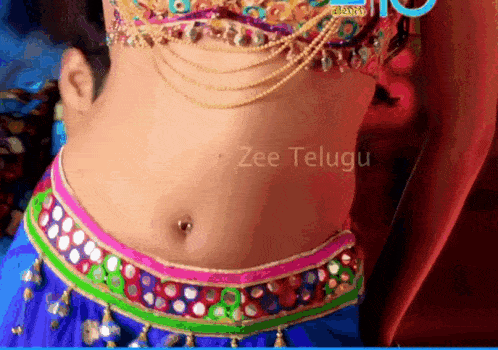 a close up of a woman 's stomach with the words zee telugu written on the bottom