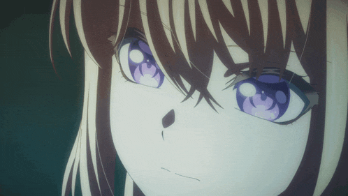 a close up of a girl 's face with a purple eye