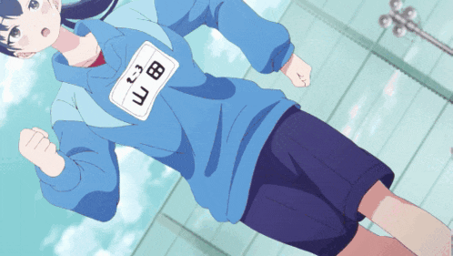 a girl in a blue shirt with a name tag that says " uc " on it