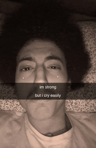 a black and white photo of a man with tears coming out of his eyes that says im strong but i cry easily on it