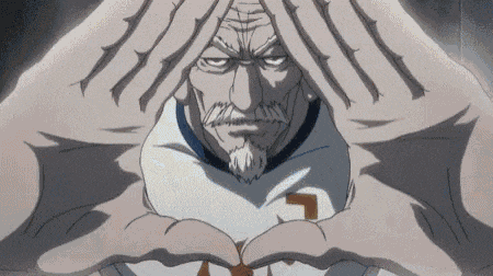 a man with a beard is making a heart shape with his hands and his head .