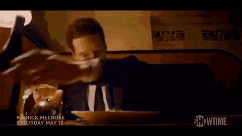 a person is cutting a piece of food on a plate that says showtime on it