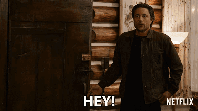 a man is standing in front of a door that says hey netflix