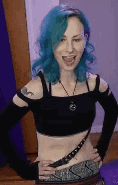 a woman with blue hair is wearing a black top and a necklace