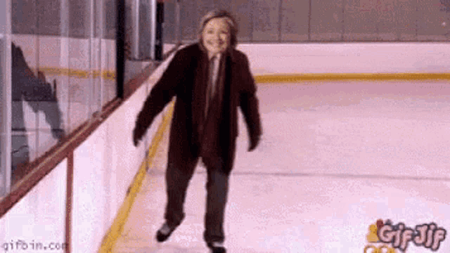a woman is ice skating on a rink with gifbin.com at the bottom