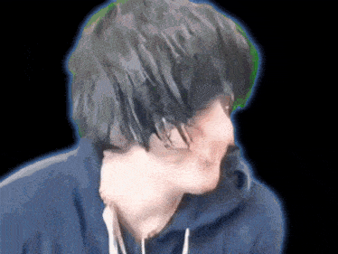 a person wearing a blue hoodie with a black background