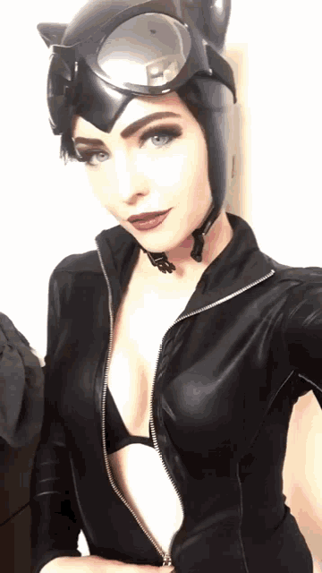 a woman in a catwoman costume is taking a picture of herself