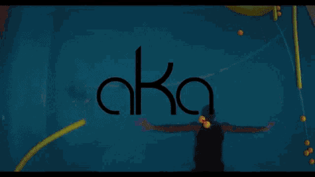 a woman in a bathing suit is laying on a green raft in a pool that says aka on the bottom