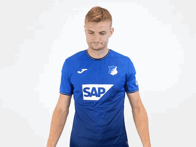 a man wearing a blue shirt with sap on it