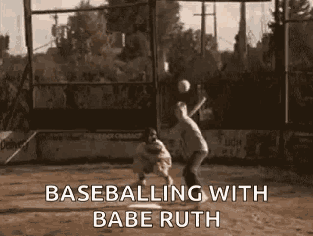 a baseball player is swinging a bat at a ball while a catcher watches .