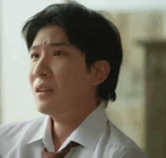 a man in a white shirt and tie is making a sad face