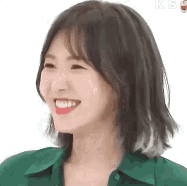 a close up of a woman with short hair smiling .