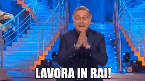 a man is standing in front of a set of stairs with his hands folded and the words lavora in rai written above him .