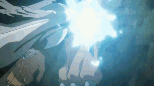 a close up of a person 's hand holding a glowing object .