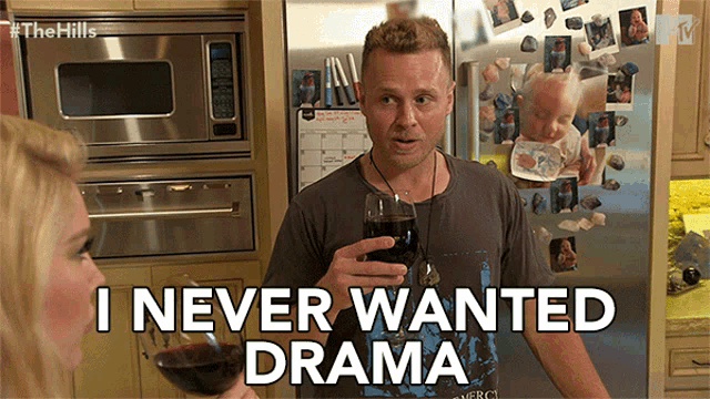 a man holding a glass of wine with the words " i never wanted drama " on the bottom
