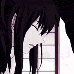 a close up of a person 's face with black hair .