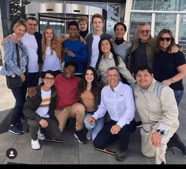 a group of people are posing for a picture together .