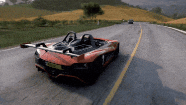 a red sports car with a license plate that has the number 1 on it is driving down the road