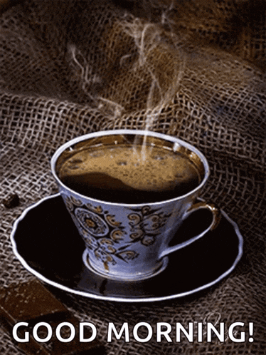 a cup of coffee on a saucer with the words good morning written on the bottom