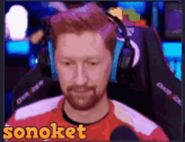 a man wearing headphones and a red shirt with the word sonoket written on it