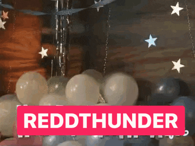 a bunch of balloons are hanging from the ceiling and a sign that says reddthunder