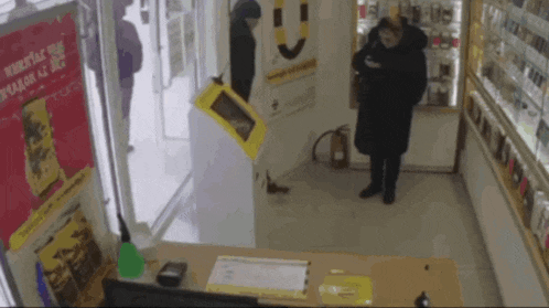 a woman standing in a store with a sign that says ' krupstak ' on it