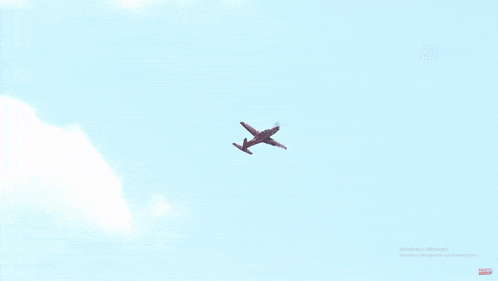 a plane is flying in a clear blue sky with the windows logo visible in the corner