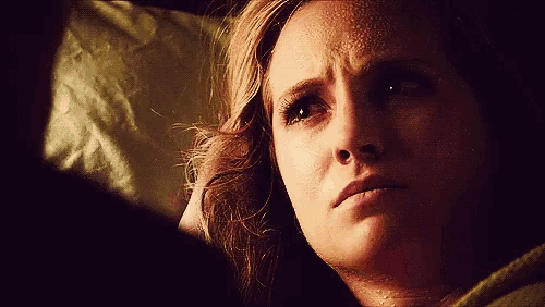 a close up of a woman 's face with a tear running down her cheek
