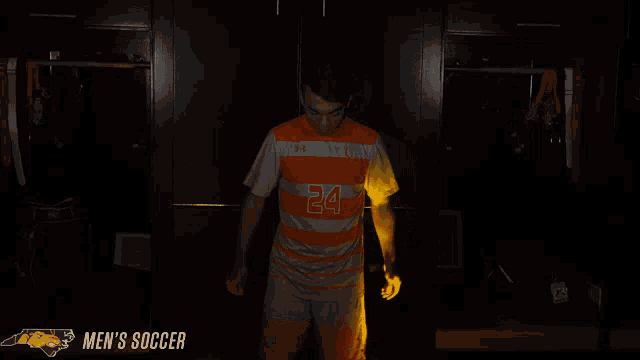 a man in an orange and grey striped jersey with the number 24 on it