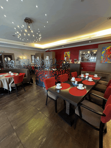 a restaurant with tables and chairs and a chandelier
