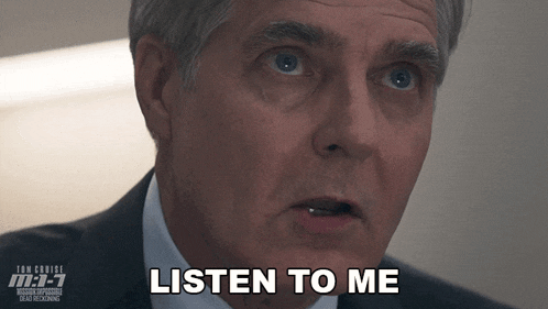 a man says listen to me in front of a poster for tom cruise