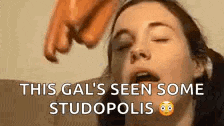 a woman with her eyes closed is being licked by a man 's hand .