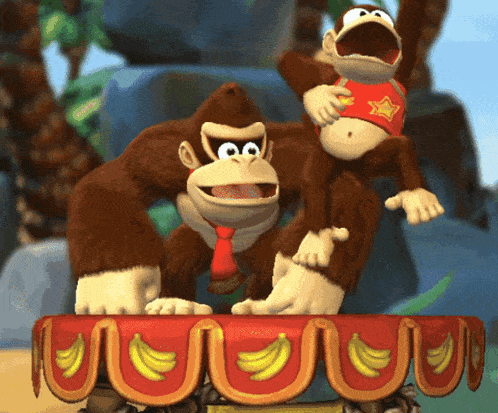 donkey kong and a monkey standing on a table with bananas