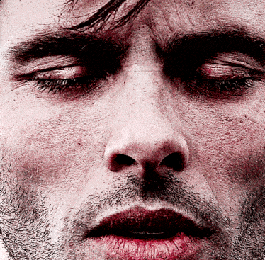 a close up of a man 's face with his eyes closed and red lips