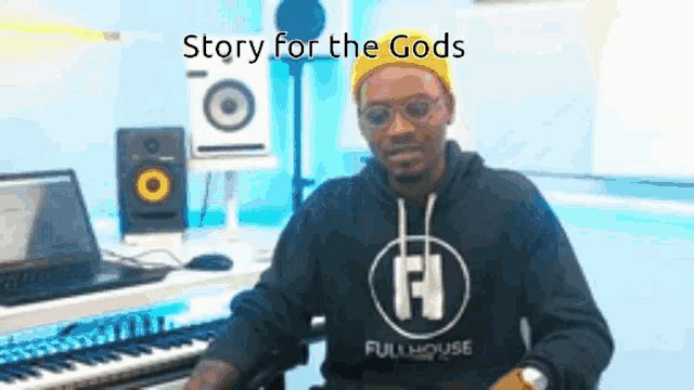 a man is sitting in front of a keyboard with the words story for the gods written above him .