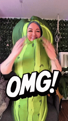 a woman in a pickle costume with the word omg on the bottom right