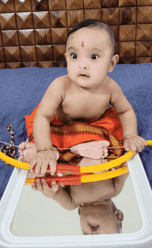 a baby playing with a toy bow and arrow