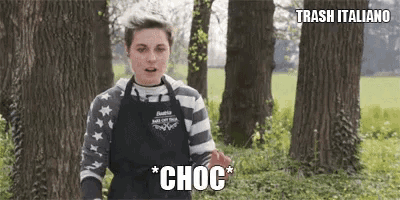 a woman in an apron is standing in front of trees and says choc
