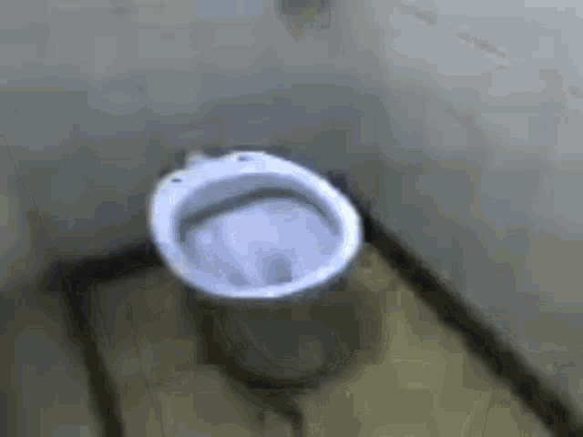 a close up of a toilet in a bathroom with a smiley face on it .