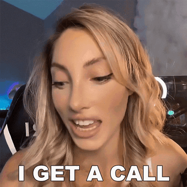 a blonde woman says i get a call in front of a computer