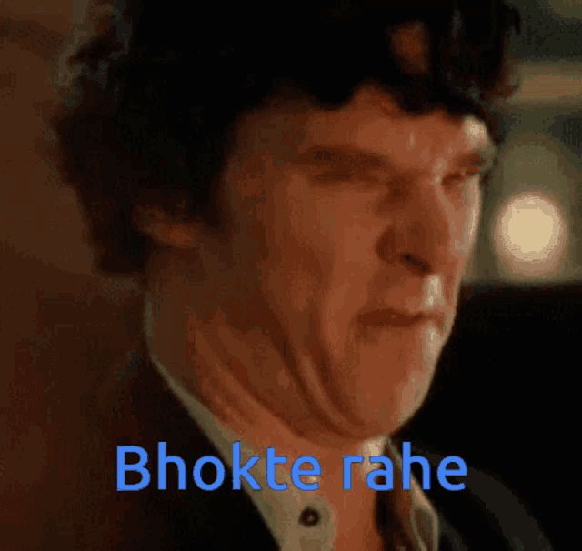 a close up of a man 's face with the words bhokte rahe written in blue