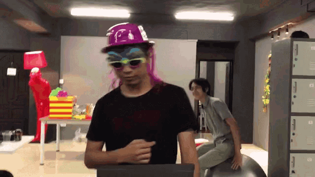 a man wearing a clown hat and sunglasses is standing in front of a row of lockers