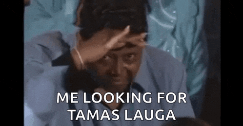 a man in a suit is covering his face with his hand and says `` me looking for tamas laura '' .