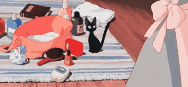a black cat is sitting on a striped rug surrounded by cosmetics and a pink bow .