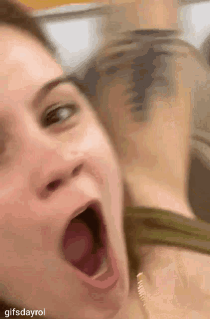 a woman is yawning with her mouth wide open