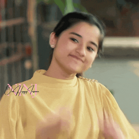 a woman wearing a yellow shirt with the words one happy indian on the bottom right
