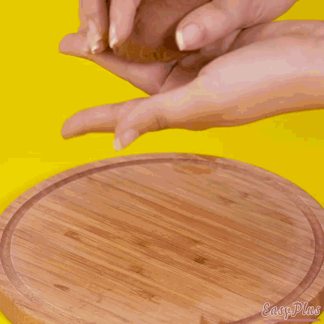 a person is holding a cookie in front of four other cookies on a baking sheet