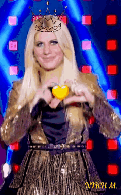 a woman wearing a crown is making a heart shape with her hands