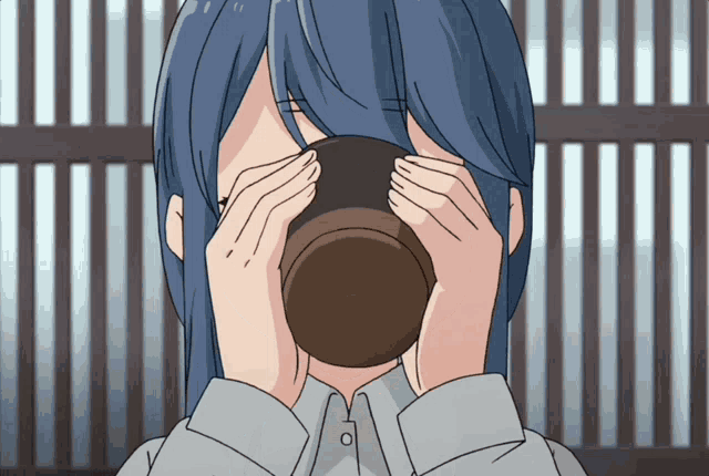 a girl with long blue hair is drinking from a cup